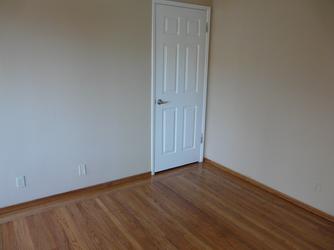 Photograph of living room area showing beautiful real wood floors.